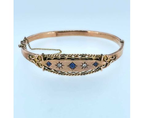 9CT GOLD BANGLE set with three sapphires and two diamonds, 10.0gms, in Crouch of Swansea boxProvenance: private collection Sw