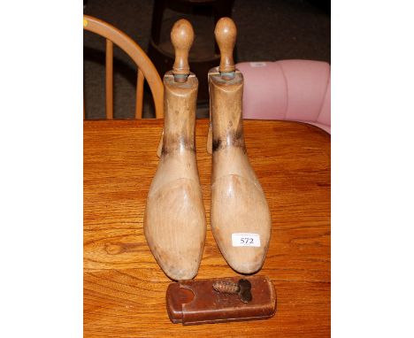 A pair of vintage wooden Heals boot trees; a leather cigar case and a pipe cleaner
