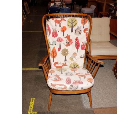 An Ercol cottage style stick back wing armchair