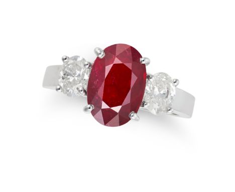 A RUBY AND DIAMOND THREE STONE RING set with an oval cut ruby of 2.74 carats, accented on each side by an oval cut diamond, t