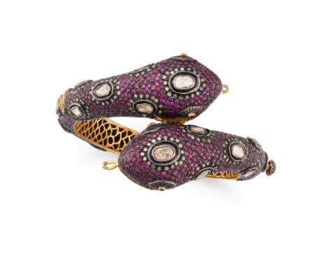 A RUBY AND DIAMOND SNAKE BANGLE the hinged bangle designed as a double headed snake, set throughout with round cut rubies, ac