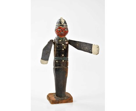 An unusual carved wooden model of a policeman, with rotating arms, height 33cm.