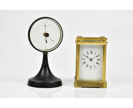 An early 20th century French brass carriage clock, the enamel dial set with Arabic and Roman numerals, height including swing
