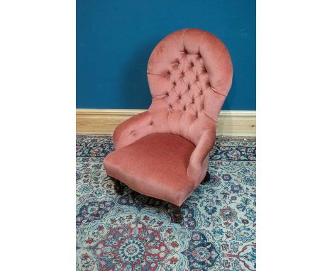 A Victorian pink button back upholstered nursing chair on turned supports.