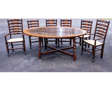 A reproduction oak oval top dining table on bobbin supports and X-stretcher, length 181cm, width 119cm, height 74cm, together