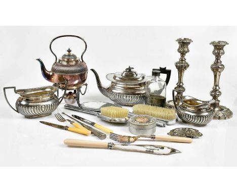 A small quantity of assorted silver plate to include a pair of 19th century candlesticks, a three piece tea service, a spirit