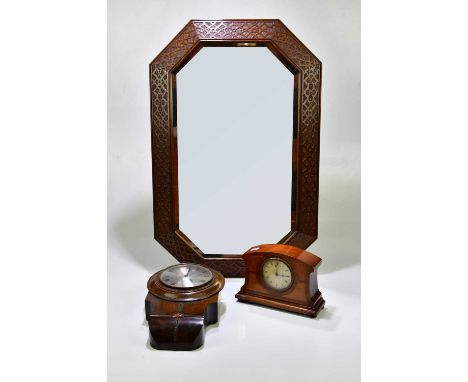A 1920s oak framed wall mirror, 80 x 55cm, together with an oak cased wall clock and a mahogany cased mantel clock.