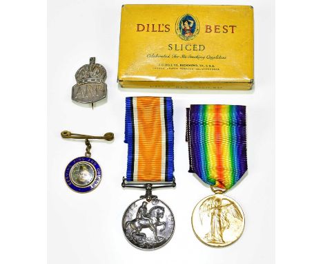 A WWI medal pair comprising War and Victory Medals named to GNR Lomax R.A., in a Dill's tobacco tin along with a 'Serving Kin