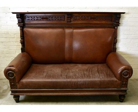 A 19th century carved walnut settle, the raised back with two carved panels, with leather back and seat, width 198cm.