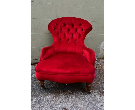 A late Victorian button upholstered low armchair.