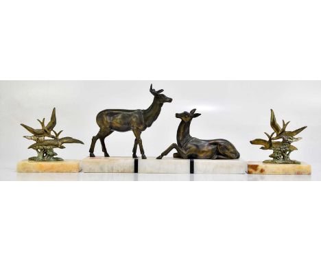 An Art Deco bronzed spelter model of a stag and doe on a marble plinth base, length 34cm, together with a pair of bronzed spe