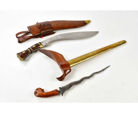 An Indonesian kris dagger in brass scabbard with embossed decoration, overall length 50cm, together with a kukri knife in lea