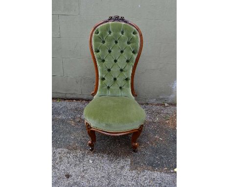 A Victorian walnut button upholstered nursing chair raised on cabriole front legs.Condition Report: General condition appears