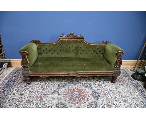 A Victorian carved mahogany settee with scroll back on turned bun feet upholstered in a green button back material, width 199