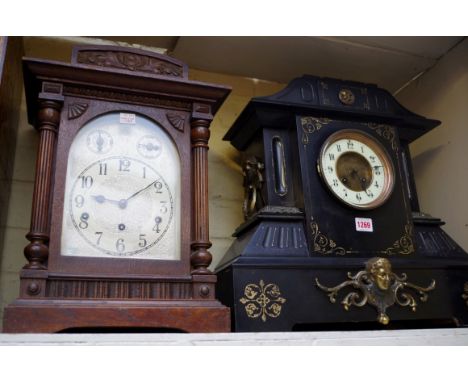 A large slate and brass mounted mantel clock, 45cm high, (lacking pendulum); together with another oak mantel clock, 43cm hig