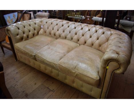 A worn pale green leather button back Chesterfield settee,&nbsp;225cm wide.&nbsp; 