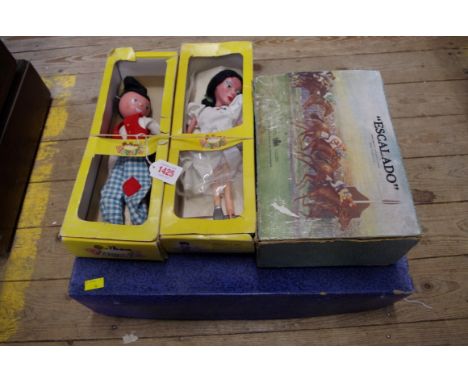 A 1930s child's pottery tea set, boxed; together with two boxed Pelham puppets; and a boxed 'Escalado' game. 