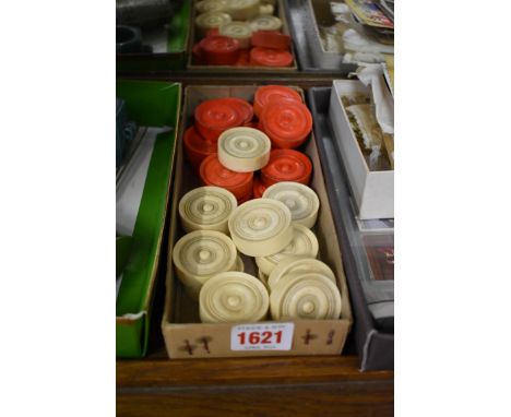 A set of 19th century bone playing counters, red stained and natural, comprising 15 red and 14 white, 38mm diameter.&nbsp; 