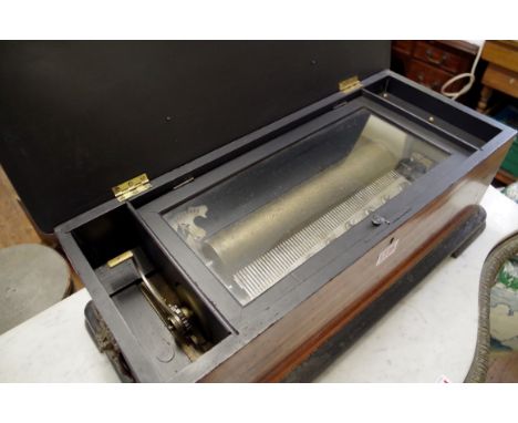 A late 19th/early 20th century rosewood, inlaid and faux grained lever wind cylinder music box,&nbsp;with 27.5cm cylinder pla