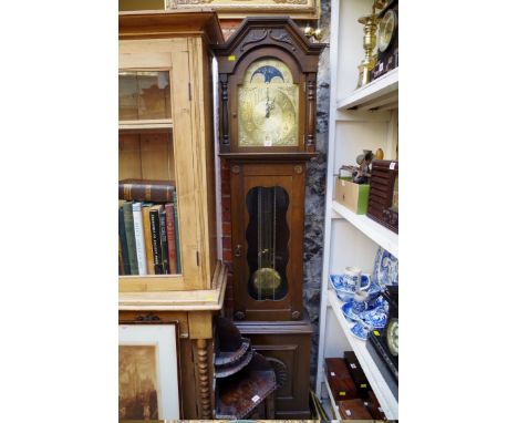 A reproduction oak longcase clock, the brass dial with moon phase arch, 201cm high, with three weights and pendulum.&nbsp; 