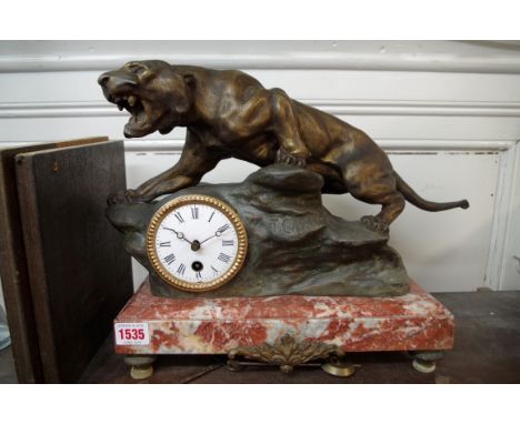 A bronzed spelter and marble figural mantel clock,&nbsp;30cm high, with pendulum and winding key.&nbsp; 