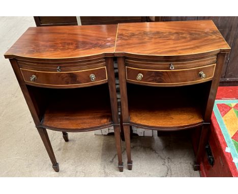 A pair of Edwardian mahogany bedside cabinets, with a slide, drawer and shelf on square legs with spade feet 66cm high x 40cm