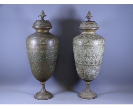 EASTERN BRASS URNS &amp; COVERS, a pair, with cone finial caps decorated with birds, animal and people among flora, 53cms ove