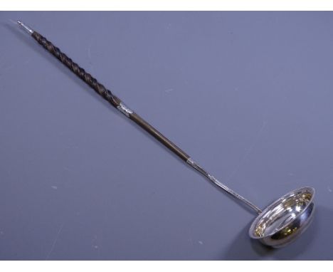 SILVER TODDY LADLE, having oval bowl with beadwork edging and a twist bone handle with silver banding and tip (marks indistin