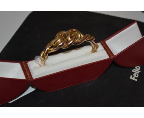 18ct gold bangle with stylised decoration in original presentation box