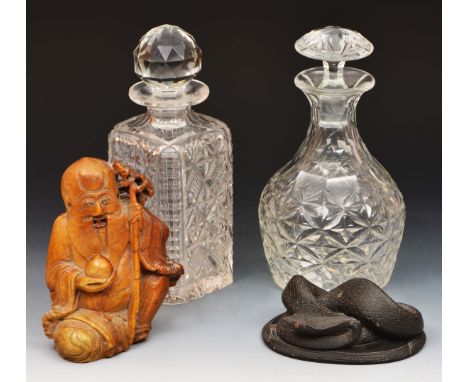 Chinese soapstone model of Shou Lao two English cut glass decanters and a slate model serpent