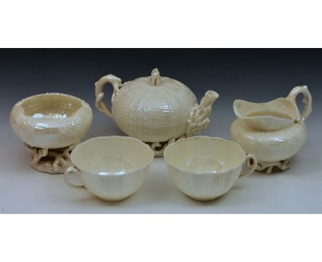 Belleek teapot and a milk jug, a sugar basin, two cups, each with coral type bases and handles and black mark