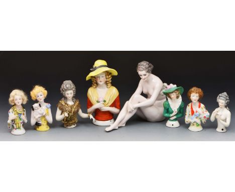 Porcelain model girl and seven pin cushion dolls