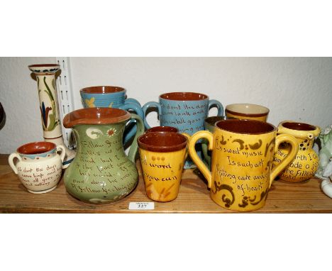 Devon pottery with inscriptions, to include a puzzle jug, loving cups, tygs and a candlestick, including Hart and Moist Exete