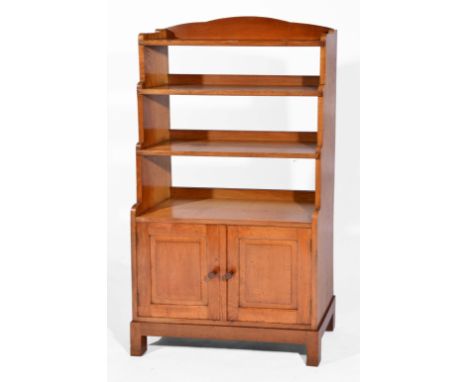Attributed to Peter Waals Arts & Crafts oak waterfall bookcase, circa 1915-20 with three step shelves above enclosed section,