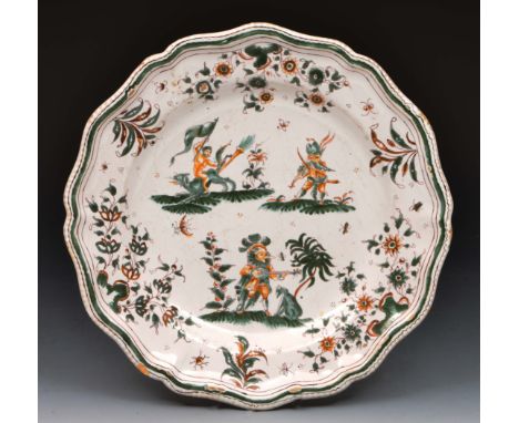 Moustiers Faience plate decorated with fantastical animals and figures within a green shaped border, 18th Century, 26cm