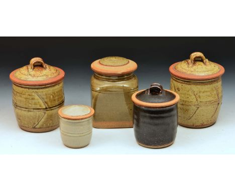 Richard Batterham Two jars and covers, ash glaze and incised motifs, 18cm high, another jar and cover with tenmoku glaze, 14c