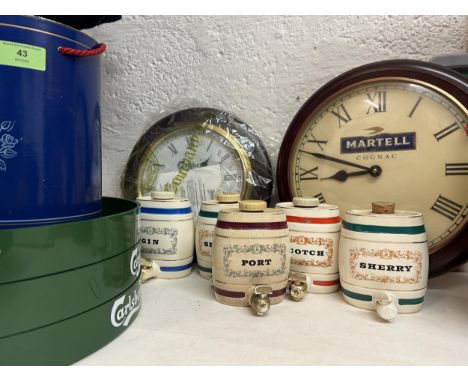 A selection of advertising memorabilia to include a Martell clock, Carlsberg clock, three trays, five Wade barrels and three 