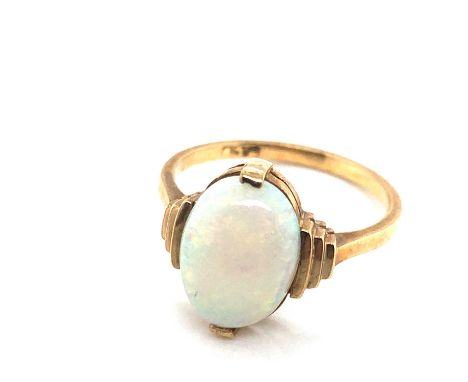 A vintage opal ring. Unhallmarked, assessed as 9ct gold. Ring size K. Weight 2.29 grams. 