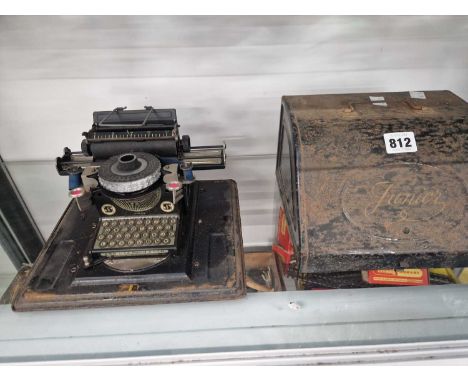A metal cased Junior rotary wheel typewriter 