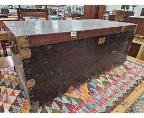 A 19th-century brass-bound teak trunk.