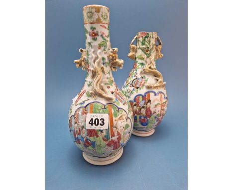 A pair of Canton bottle vases with figures painted below the gilt Buddhist lion handles, one converted to a table lamp. H 25c