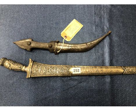 A large Malayan Kris, 51 cm watered steel blade, with silver wrapped hilt and scabbard. Together with a small Arabic Jambiya.