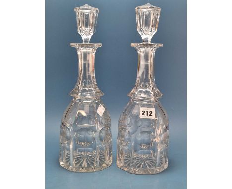 Two similar cut glass decanters, a ruby overlay globe and shaft scent decanter, a cranberry table bell together with a spheri