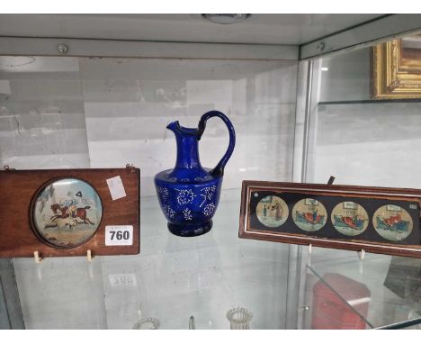 Two wooden framed magic lantern slides together with a blue glass ewer