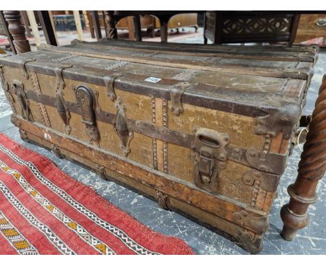 A wood and leather-bound antique cabin trunk. 