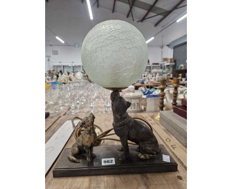 An Art Deco Ball form table lamp, the globe light supported on a dogs snout with a puppy looking on.