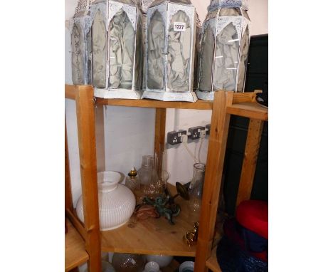 Six glazed hanging lanterns, a bronze cherub hanging light, various brass oil lamps with some converted for electricity and a