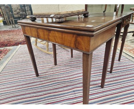 A george III mahogany foldover card table.