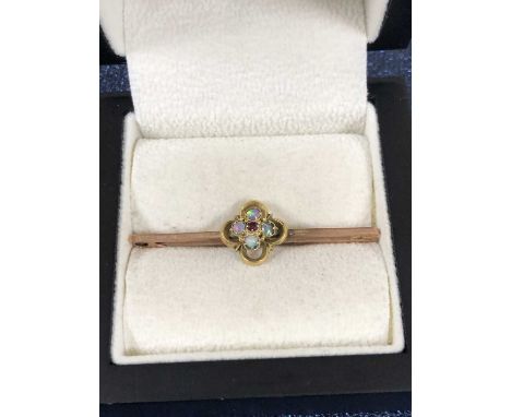 A vintage opal cluster bar brooch, Unhallmarked, assessed as a 9ct bar and 16ct gold cluster. Length 4.4 cm. Weight 2.52 gram