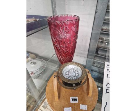 A gyroscope set compass together with a cranberry overlay glass vase